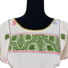 Cargar imagen en el visor de la galería, Blusa grande de corte recto con bordados de hilván tradicionales de Puebla, en color blanco con detalles en pecho, mangas y parte inferior. Hecha por Hilaria Gómez.