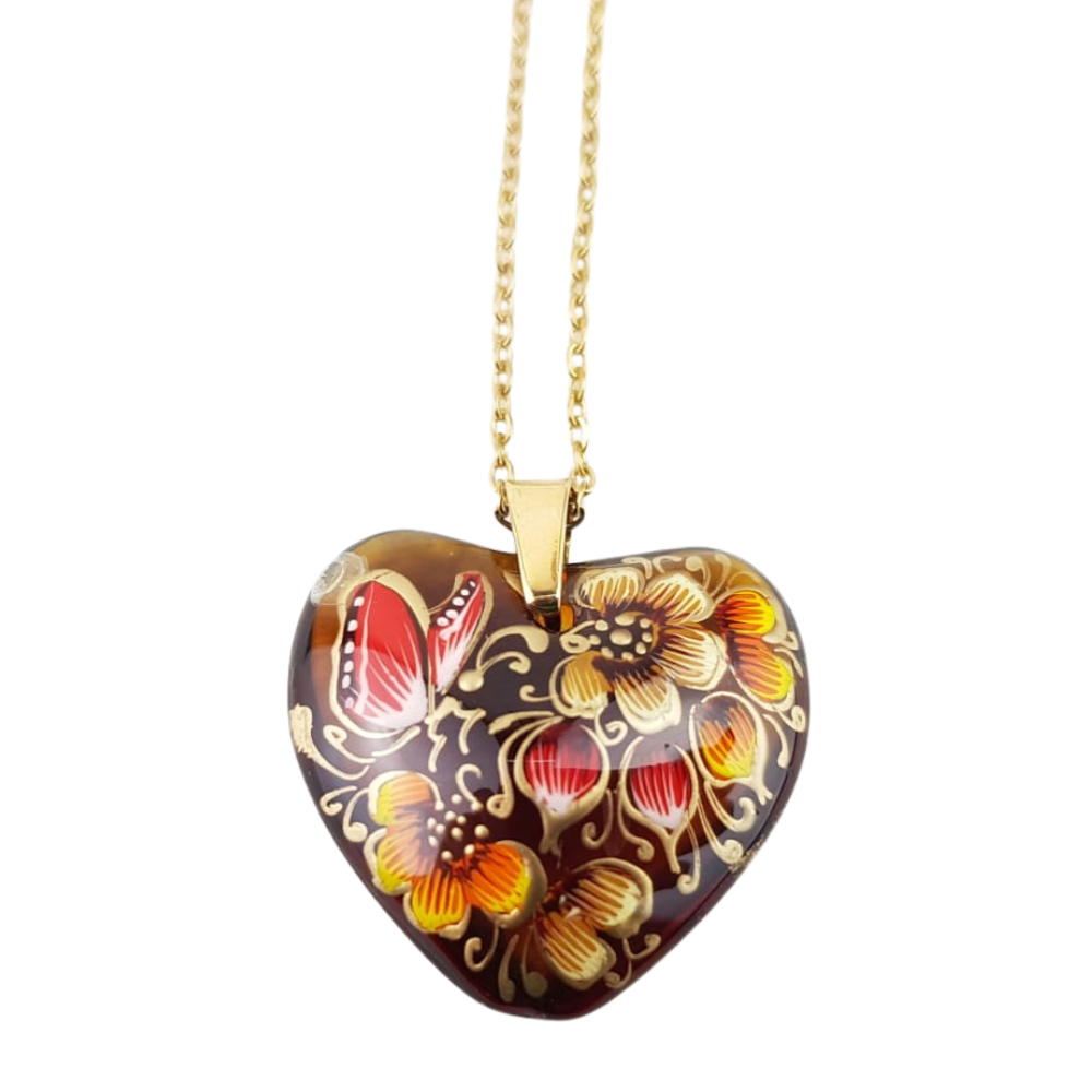 Dije de corazón de cristal decorado con flores y mariposas
