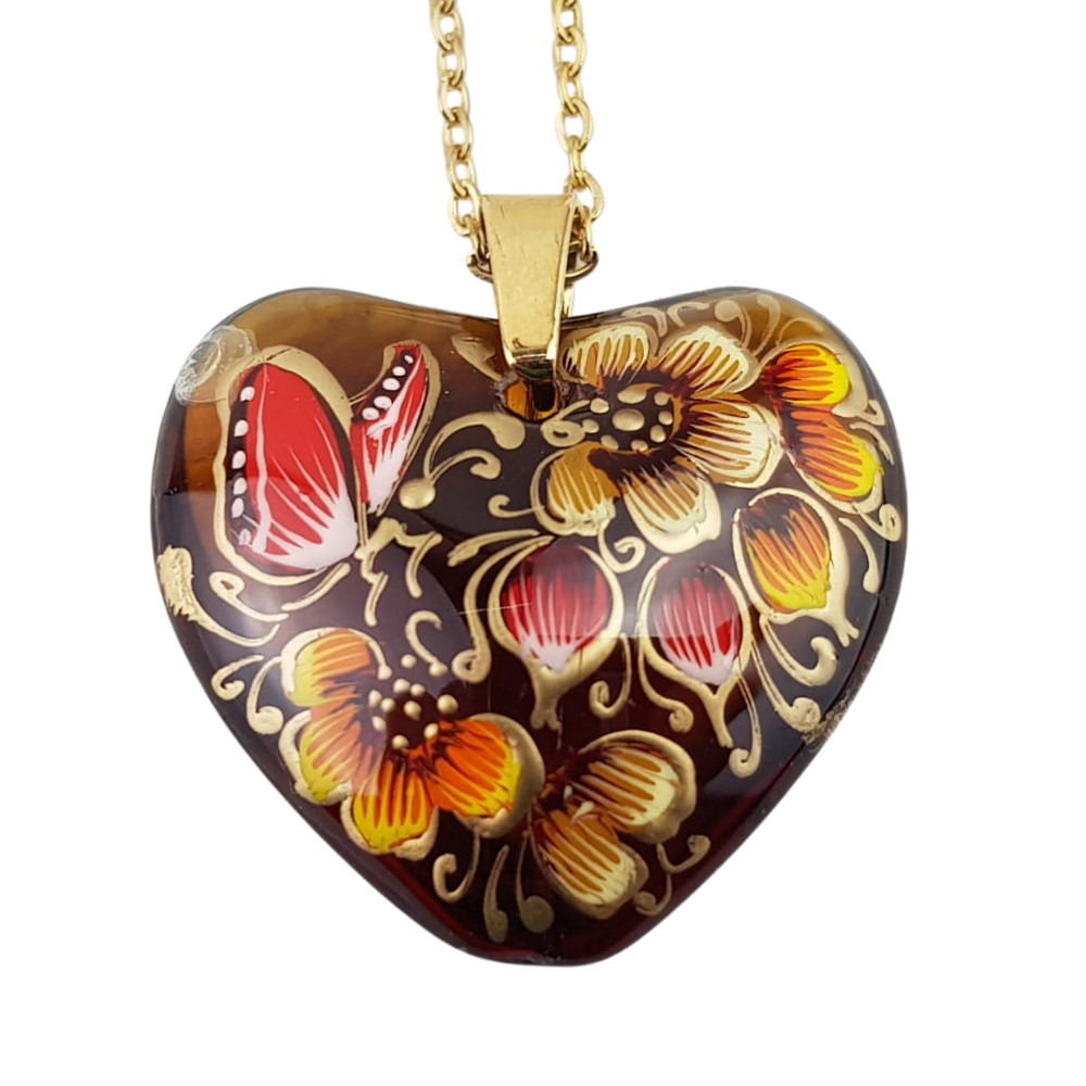 Dije de corazón de cristal decorado con flores y mariposas