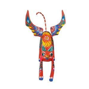 Alebrije oaxaqueño gato o perro con alas de madera copal