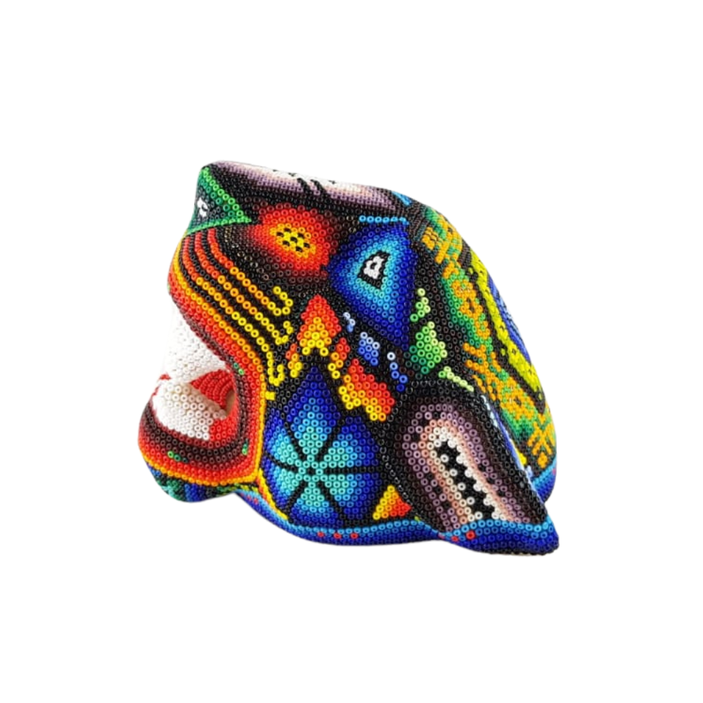 Cabeza de jaguar hecha de madera tallada a mano y decorada con motivos wixárika