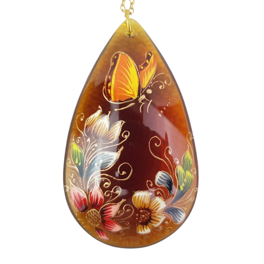 Dije de gota grande de cristal decorado con flores y mariposas