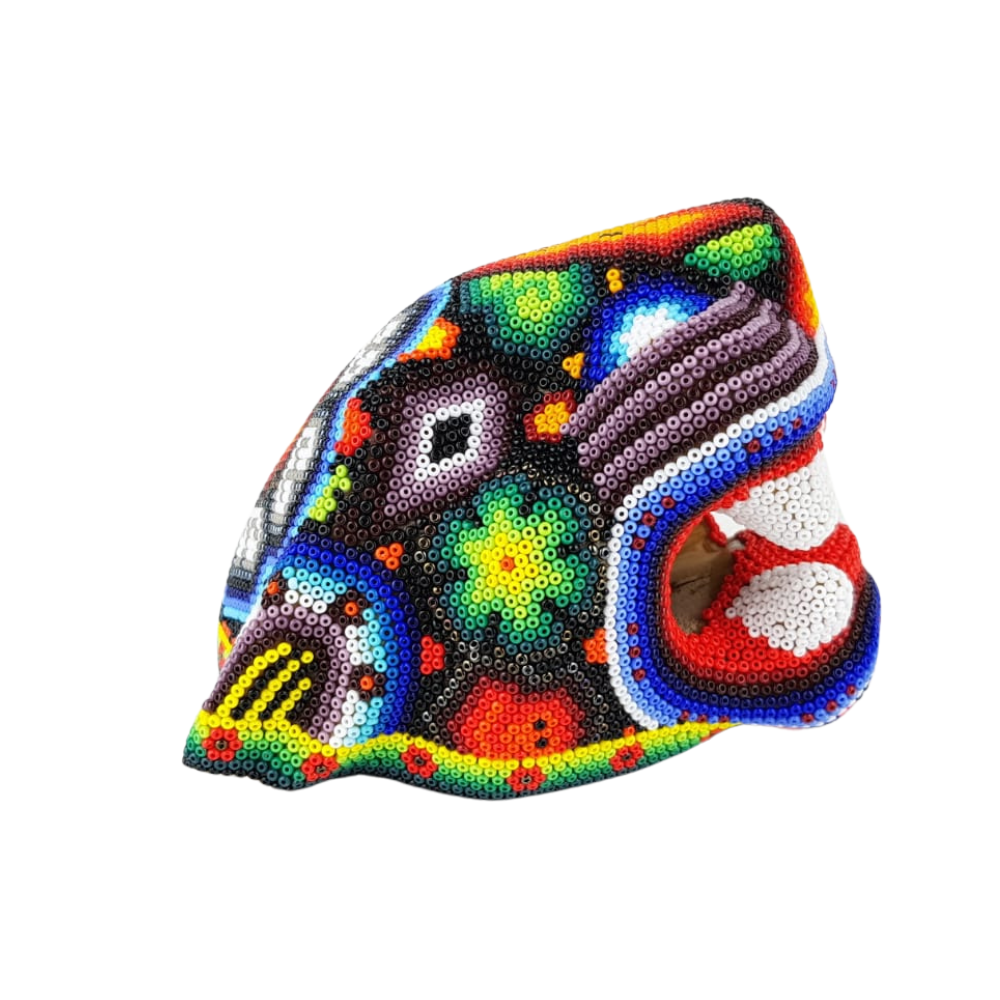 Cabeza de jaguar hecha de madera tallada a mano y decorada con motivos wixárika